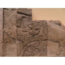 Relief, lion biting the backside of a bull
